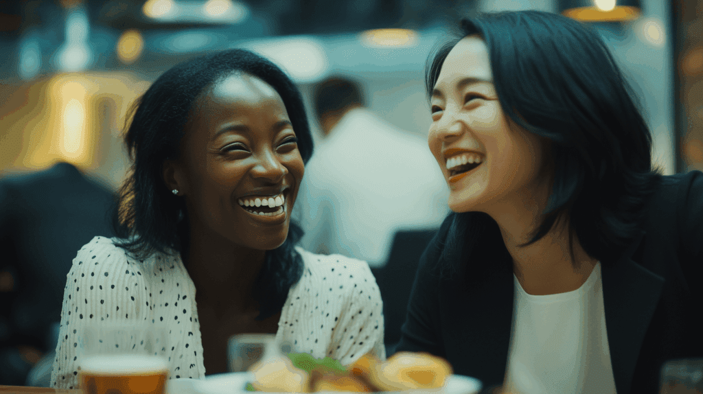 Two female colleagues laughing together
