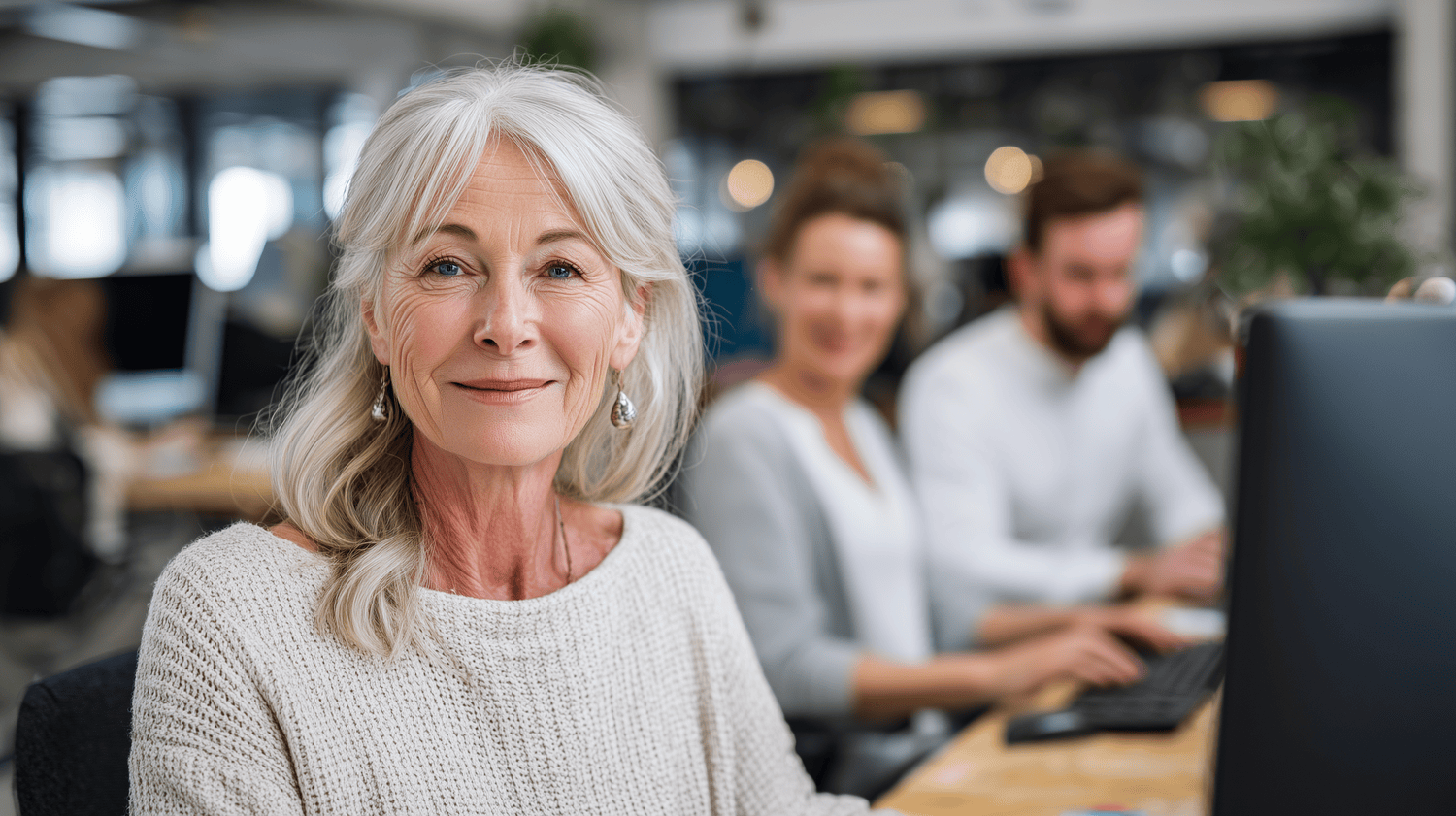 Senior HR Manager smiling at her desk